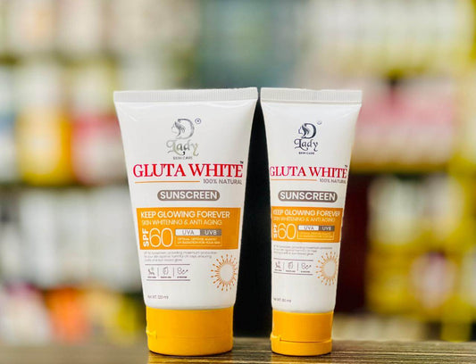 Two D Lady Gluta White sunscreen tubes with yellow flip-top caps, displaying SPF 60 and UVA and UVB markings.